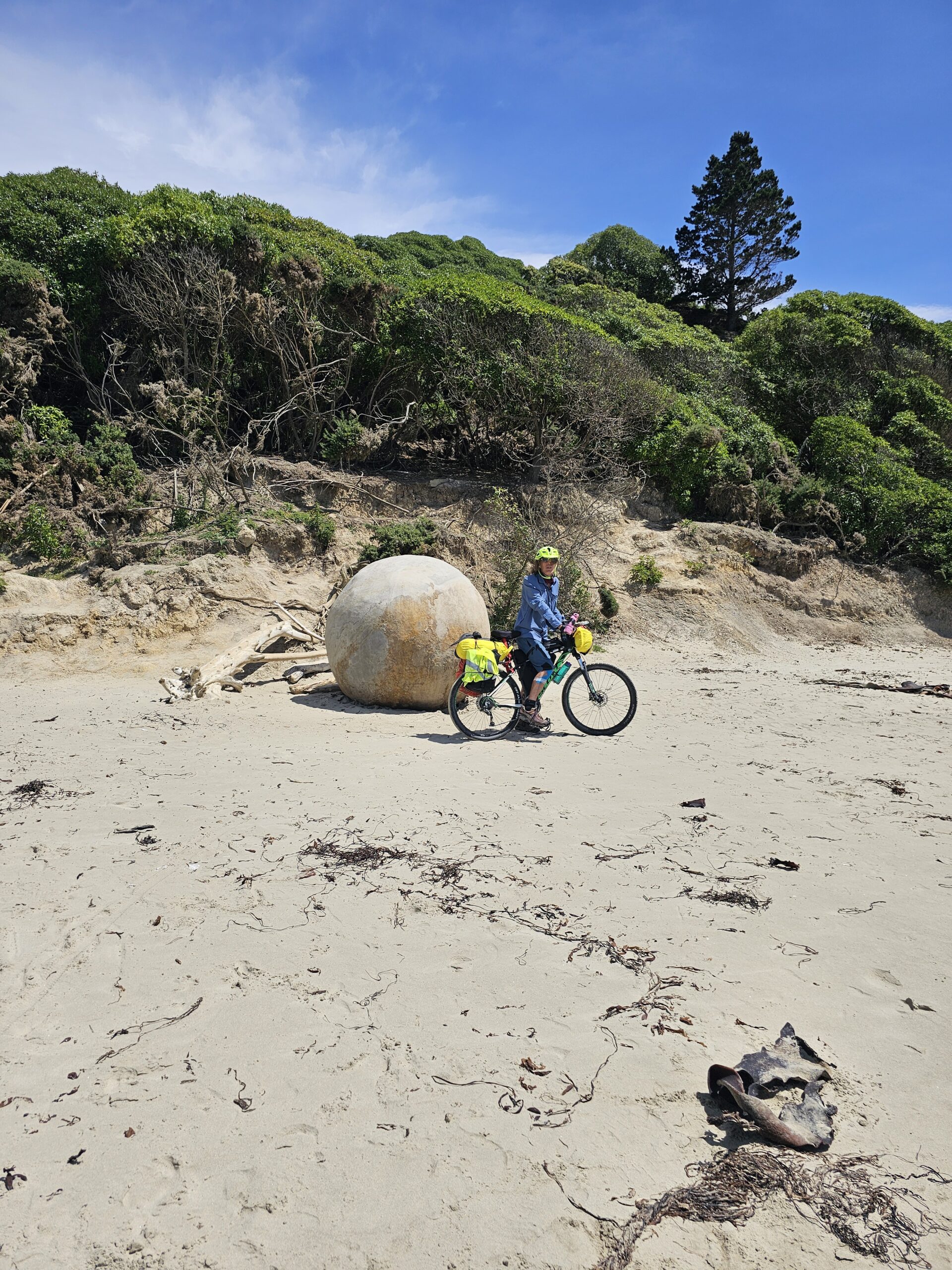 Biking on the beach at the Moeraki Boulders